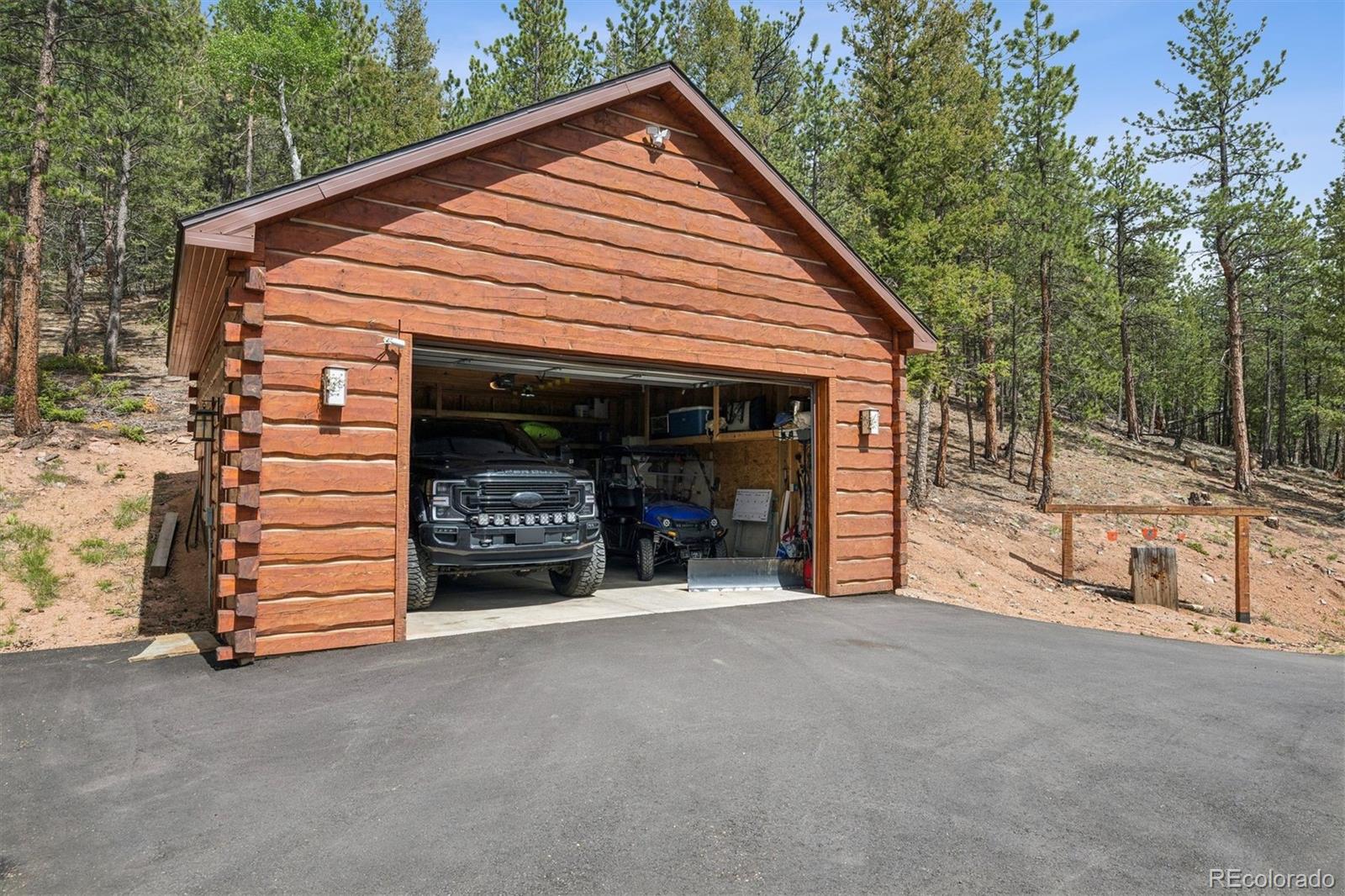 2894 County Road 43 Bailey, CO 80421 - Photo 24 of 40 a view of a house with a garage and yard