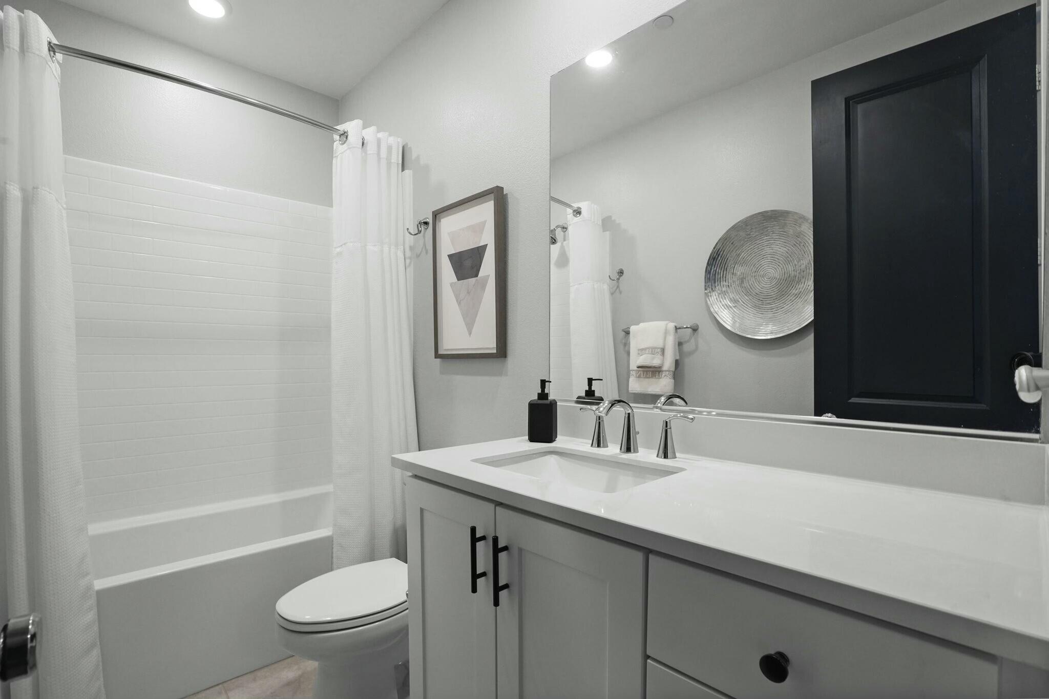 26976 West Prospector Road, Unit 205 Valencia, CA 91381 - Photo 22 of 31 a bathroom with a double vanity sink toilet mirror and shower