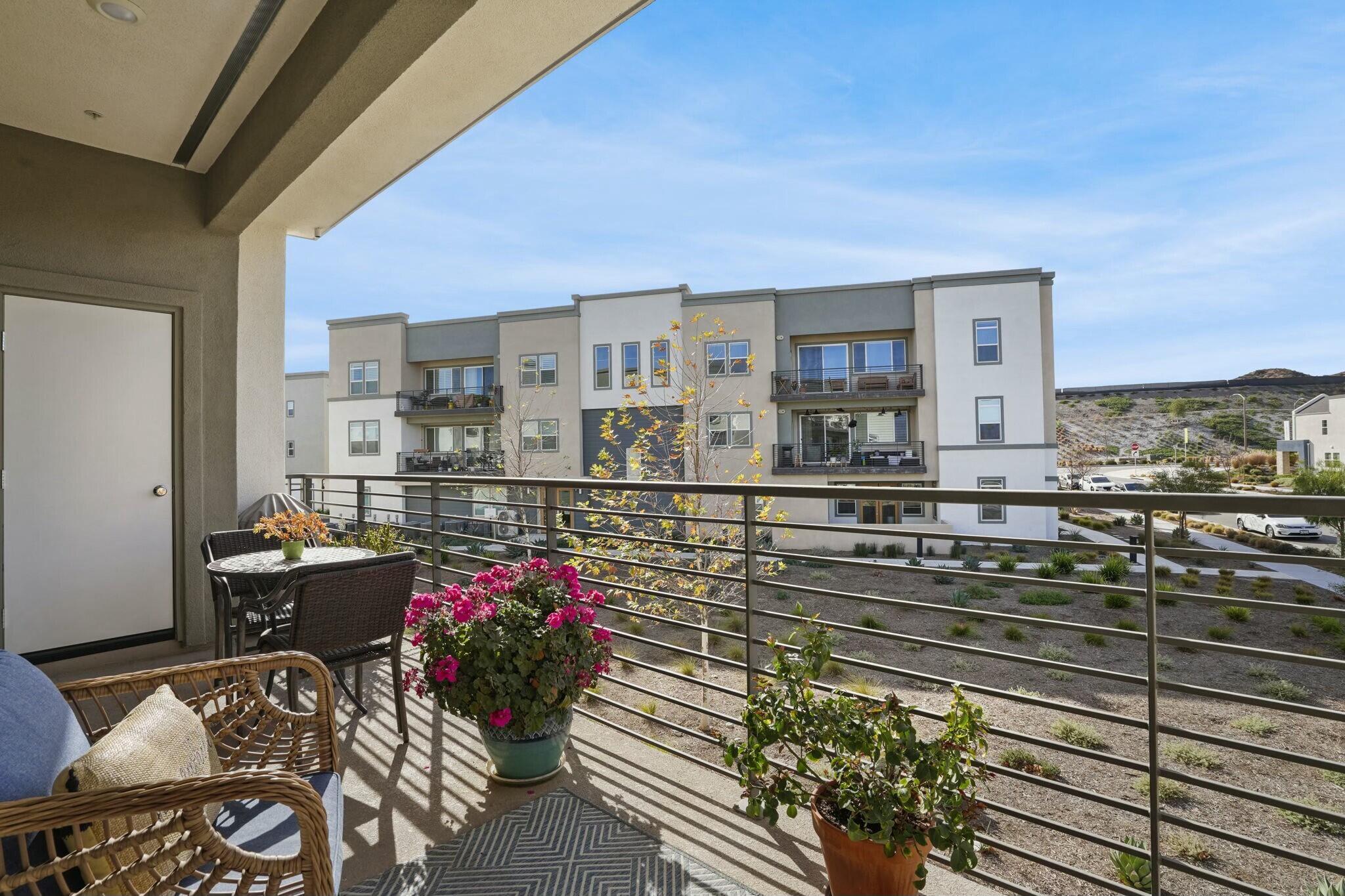 26976 West Prospector Road, Unit 205 Valencia, CA 91381 - Photo 26 of 31 a view of a chairs and table in the balcony