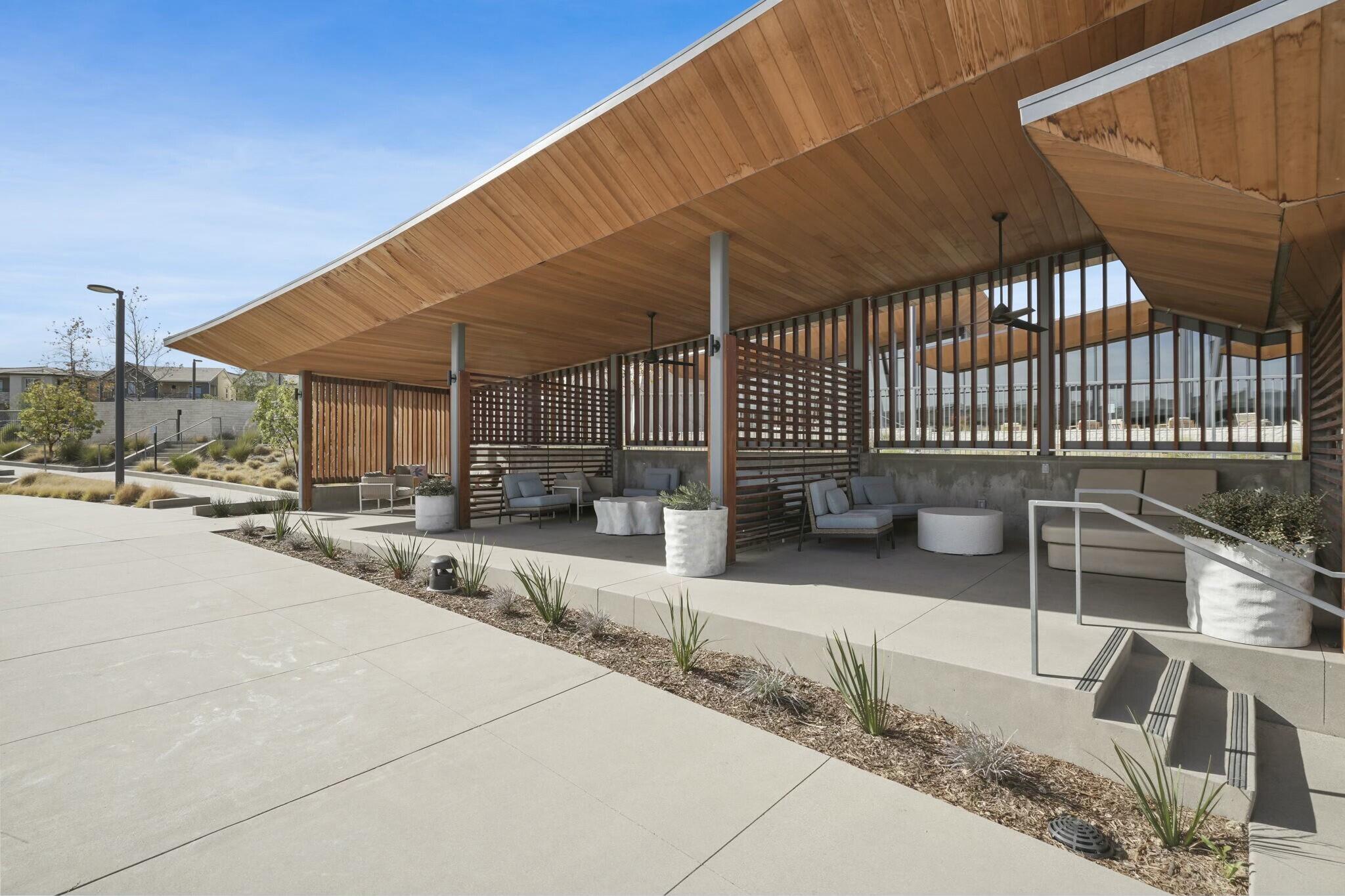 26976 West Prospector Road, Unit 205 Valencia, CA 91381 - Photo 29 of 31 a view of a patio with table and chairs with wooden fence