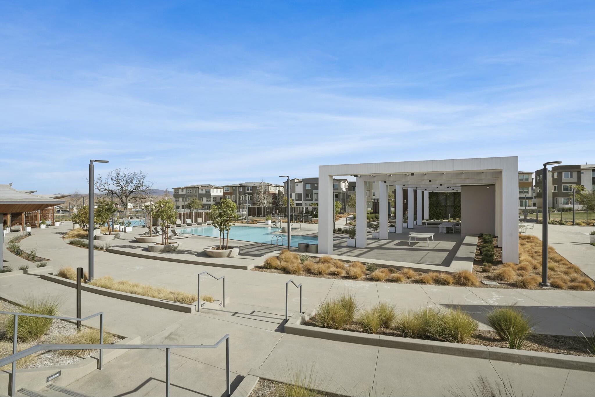 26976 West Prospector Road, Unit 205 Valencia, CA 91381 - Photo 31 of 31 a view of a swimming pool and a chairs