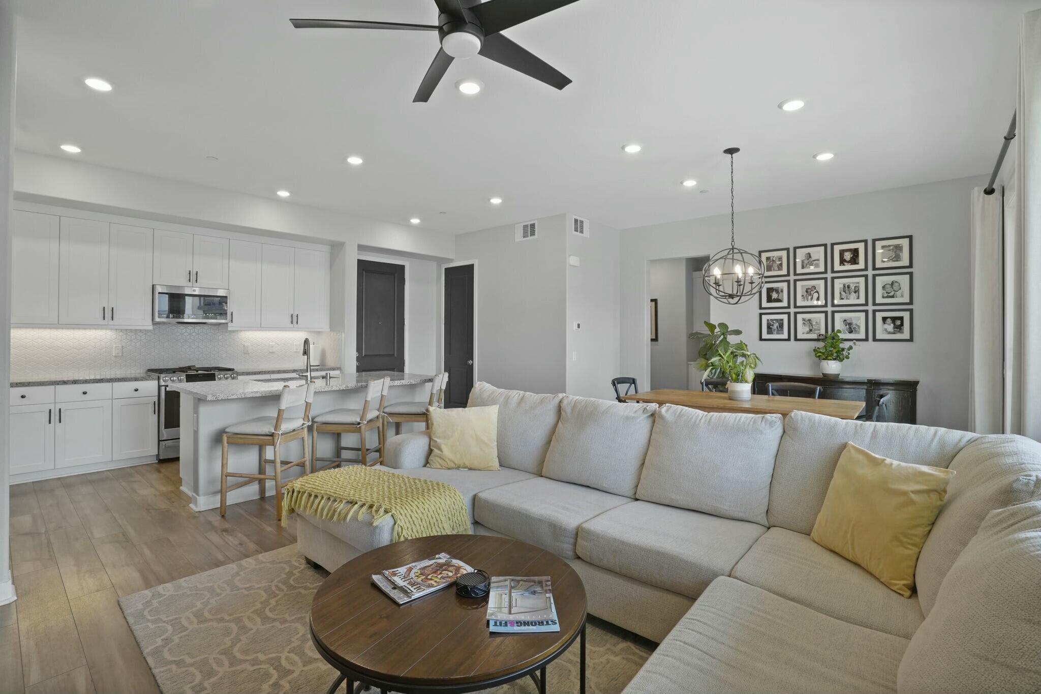 26976 West Prospector Road, Unit 205 Valencia, CA 91381 - Photo 7 of 31 a living room with furniture kitchen view and a chandelier