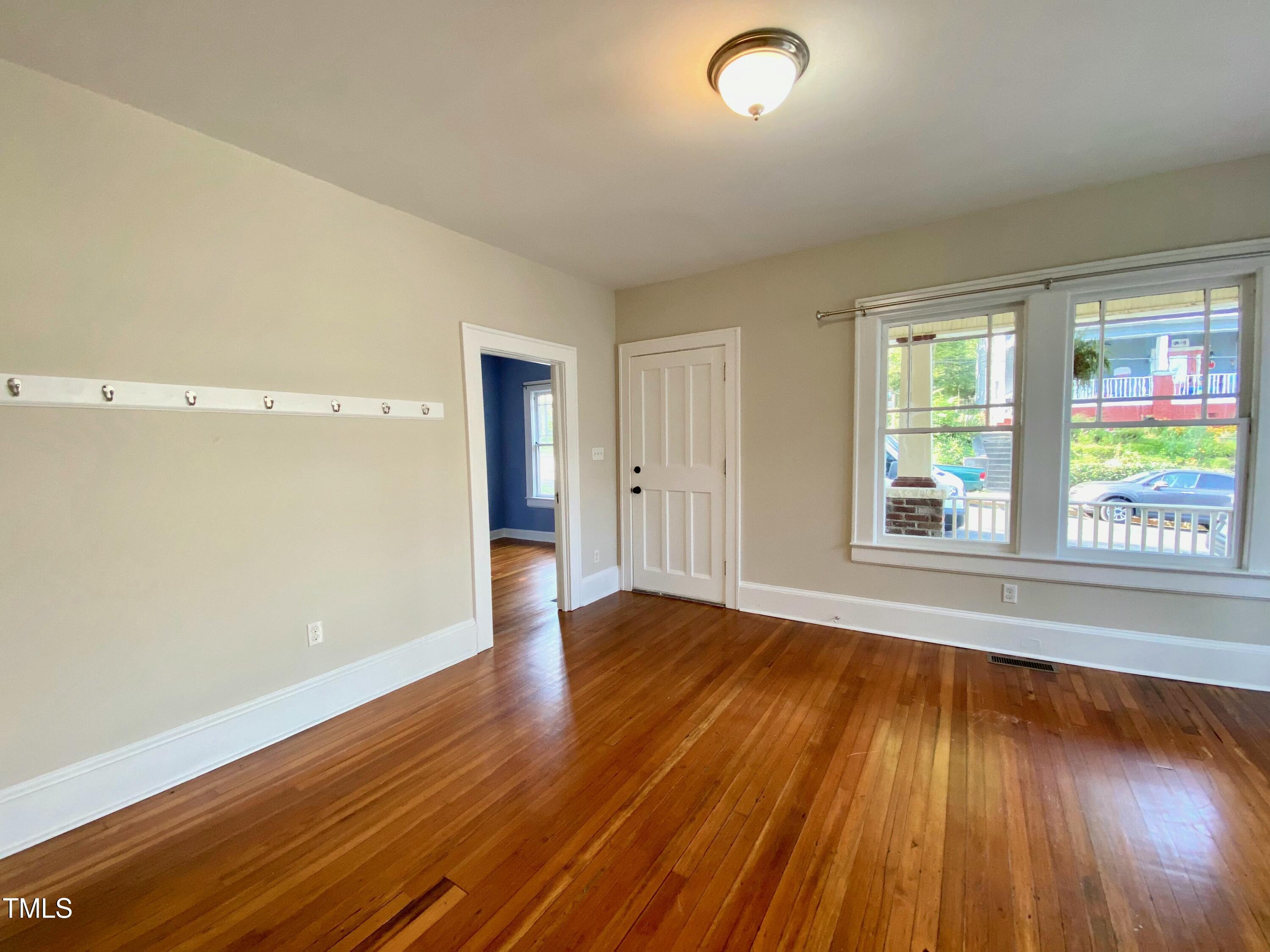 407 Ottawa Avenue Durham, NC 27701 - Photo 13 of 30 an empty room with wooden floor and windows