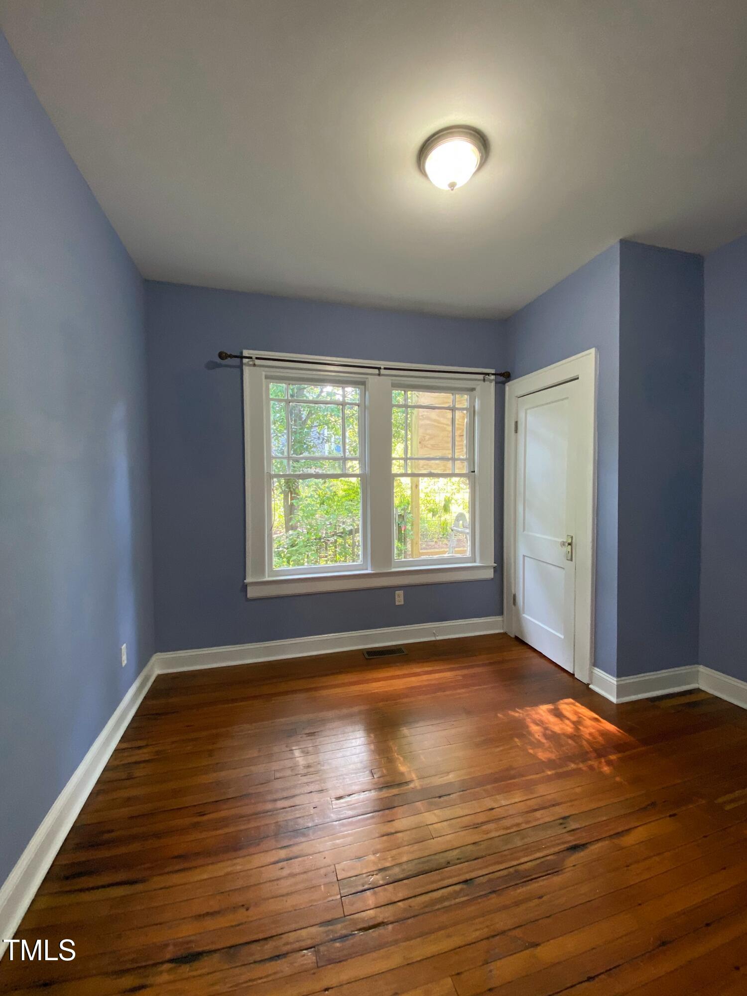407 Ottawa Avenue Durham, NC 27701 - Photo 17 of 30 an empty room with wooden floor and windows