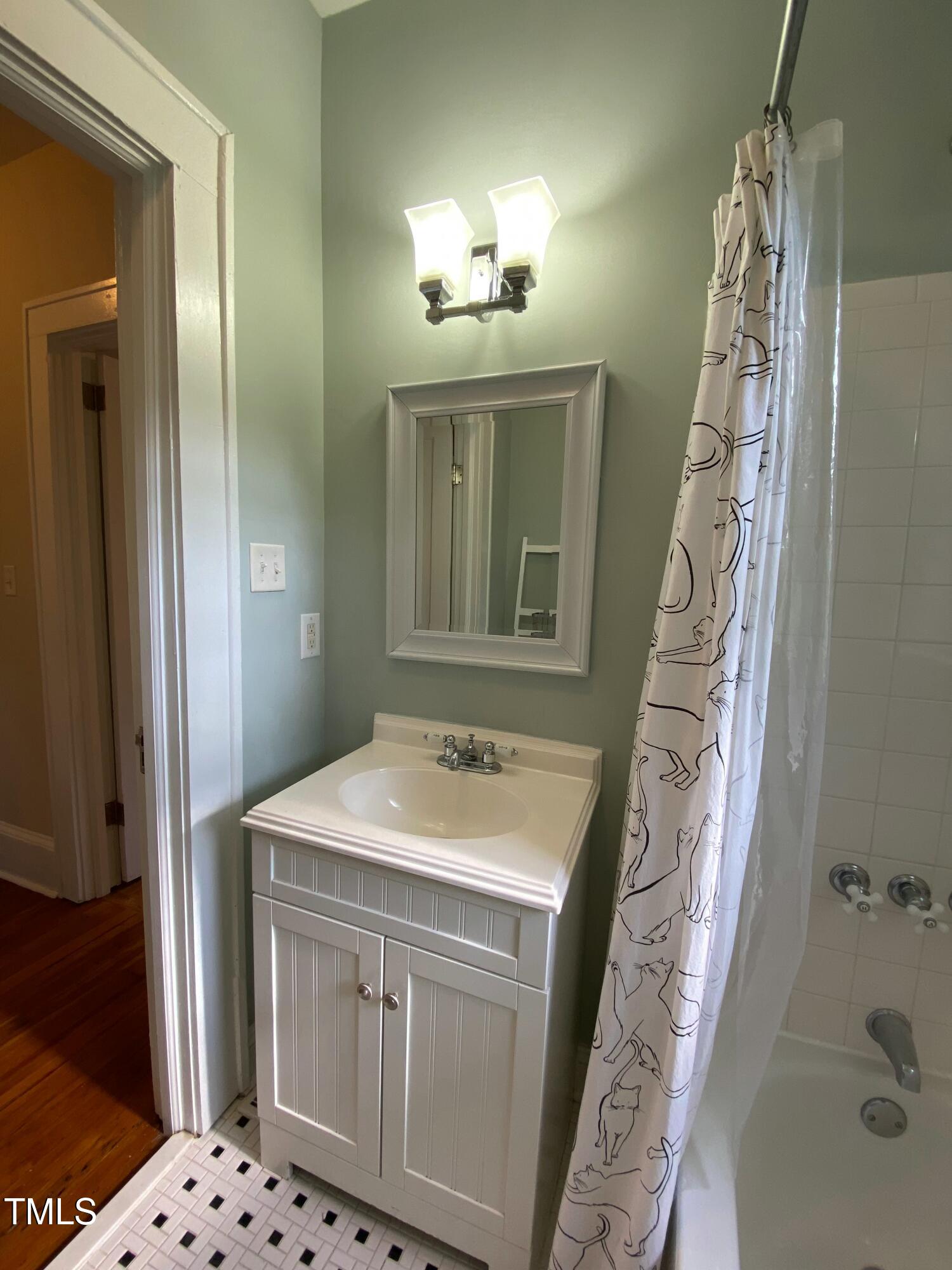 407 Ottawa Avenue Durham, NC 27701 - Photo 19 of 30 a bathroom with a sink and a mirror