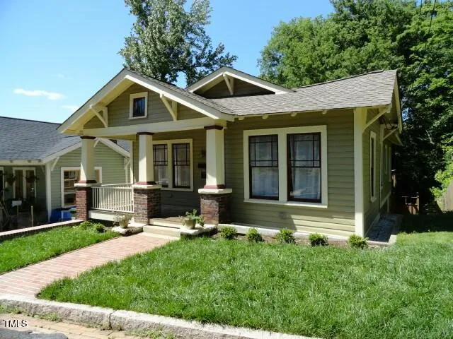 a view of a house with a yard and plants