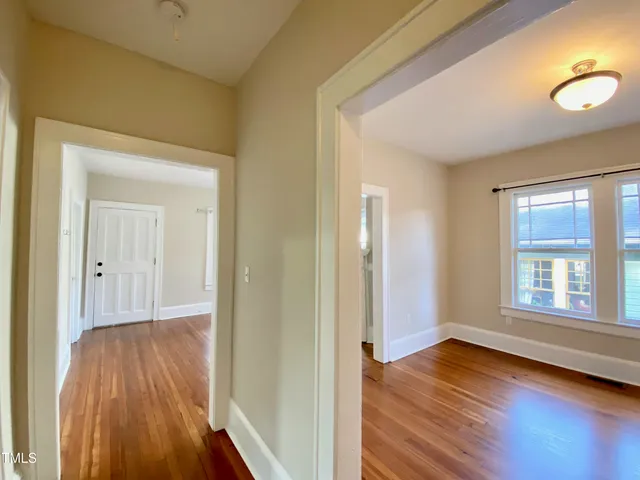 a view of a livingroom with wooden floor and window