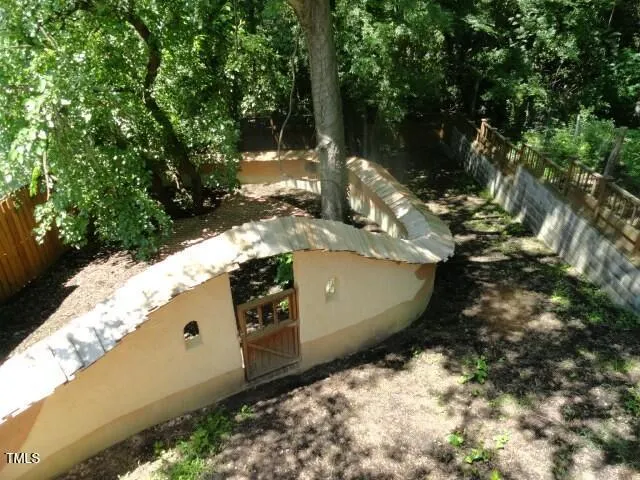 a view of a wooden house with a yard