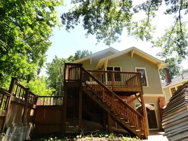 a view of a house with wooden fence