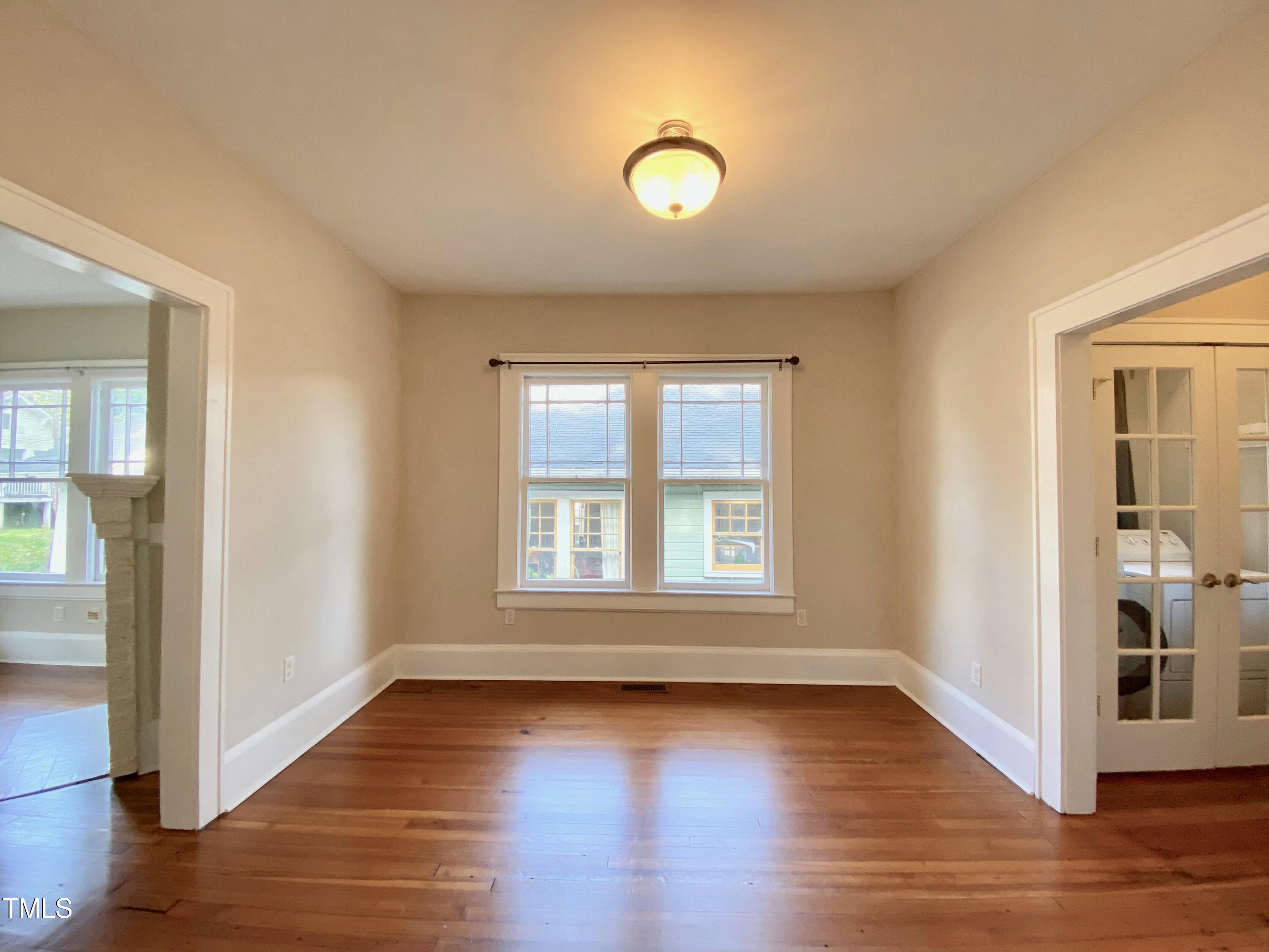 407 Ottawa Avenue Durham, NC 27701 - Photo 6 of 30 an empty room with wooden floor and windows