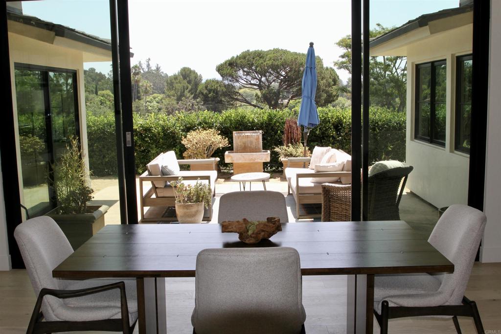 6173 Paseo Arbolado Rancho Santa Fe, CA 92067 - Photo 11 of 16 a dining room with furniture a chandelier and glass door