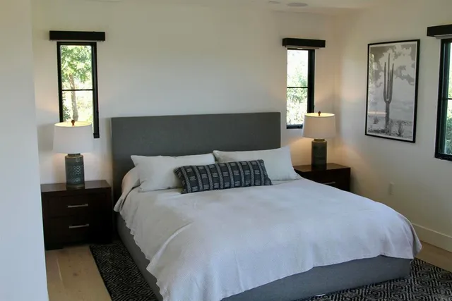 a bedroom with a bed and wooden floor