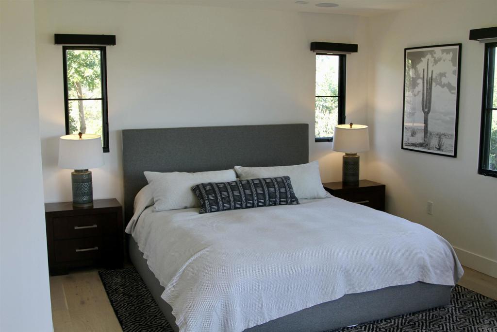 6173 Paseo Arbolado Rancho Santa Fe, CA 92067 - Photo 12 of 16 a bedroom with a bed and wooden floor