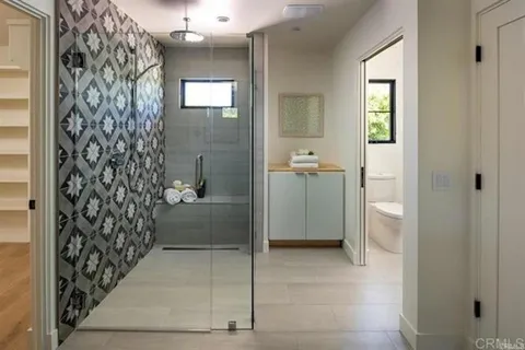 a bathroom with a shower and a sink