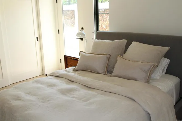 a bedroom with a bed and a window