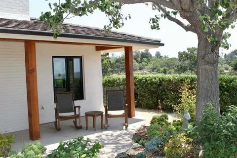 a view of a two chairs in the balcony
