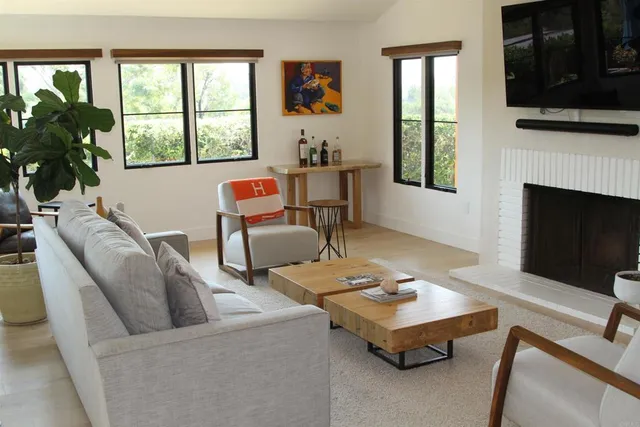 a living room with furniture and a fireplace