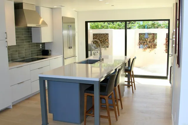 a dining room with kitchen island a table and chairs
