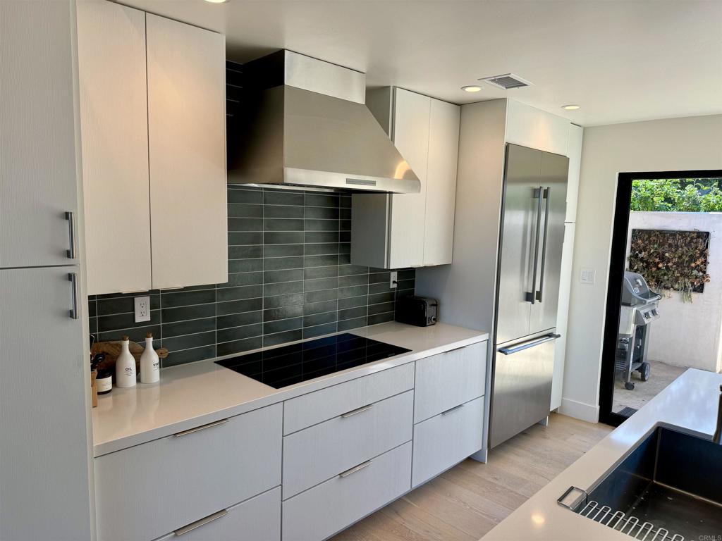 6173 Paseo Arbolado Rancho Santa Fe, CA 92067 - Photo 8 of 16 a kitchen with a sink stove and refrigerator