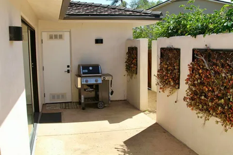 a view of kitchen with furniture and a refrigerator