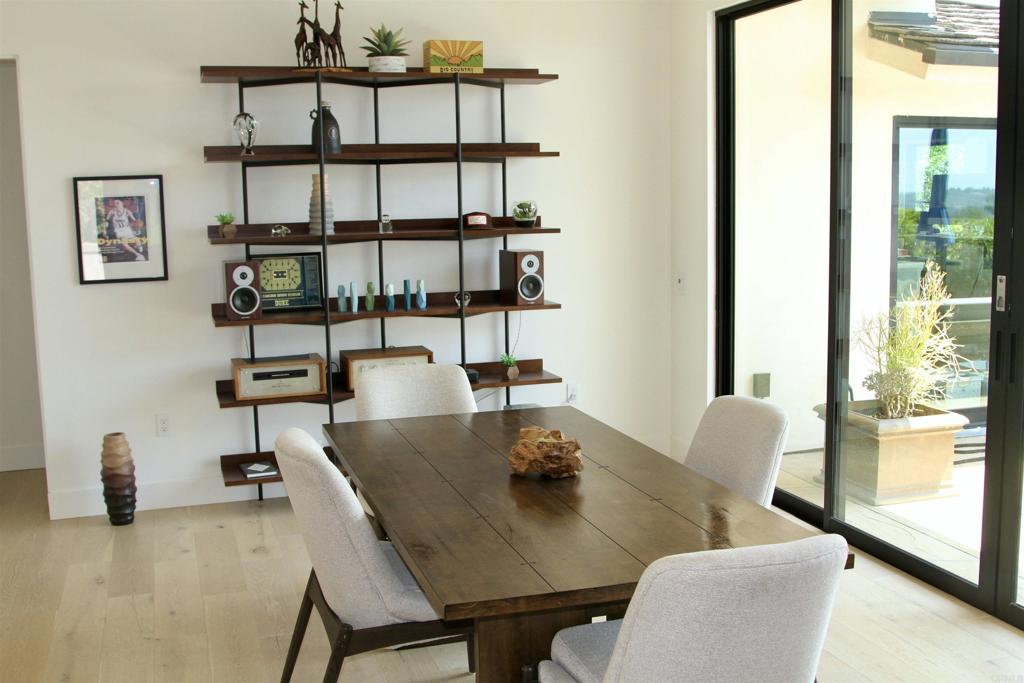 6173 Paseo Arbolado Rancho Santa Fe, CA 92067 - Photo 10 of 16 a view of a dining room with furniture and wooden floor