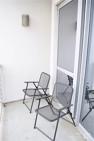 a view of a patio with a table and chairs