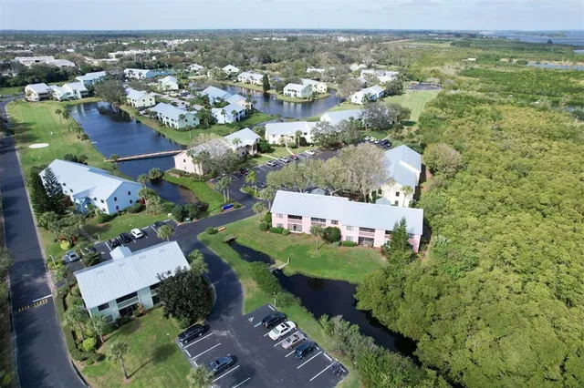 an aerial view of multiple houses with a yard