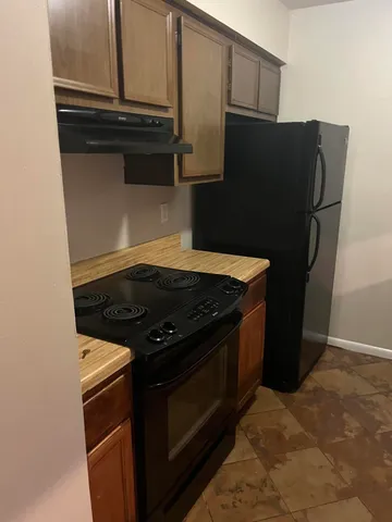 a stove top oven sitting inside of a kitchen