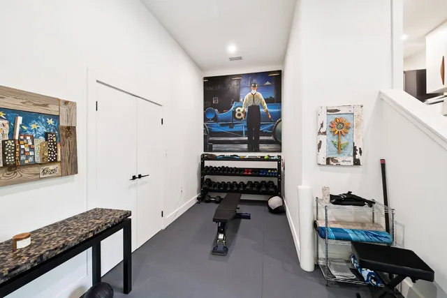 a view of a workspace with furniture and stairs