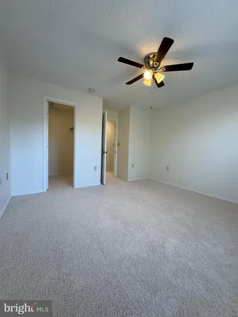 a view of a livingroom with a ceiling fan and window