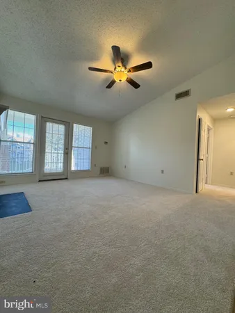 a view of a livingroom with a ceiling fan and window
