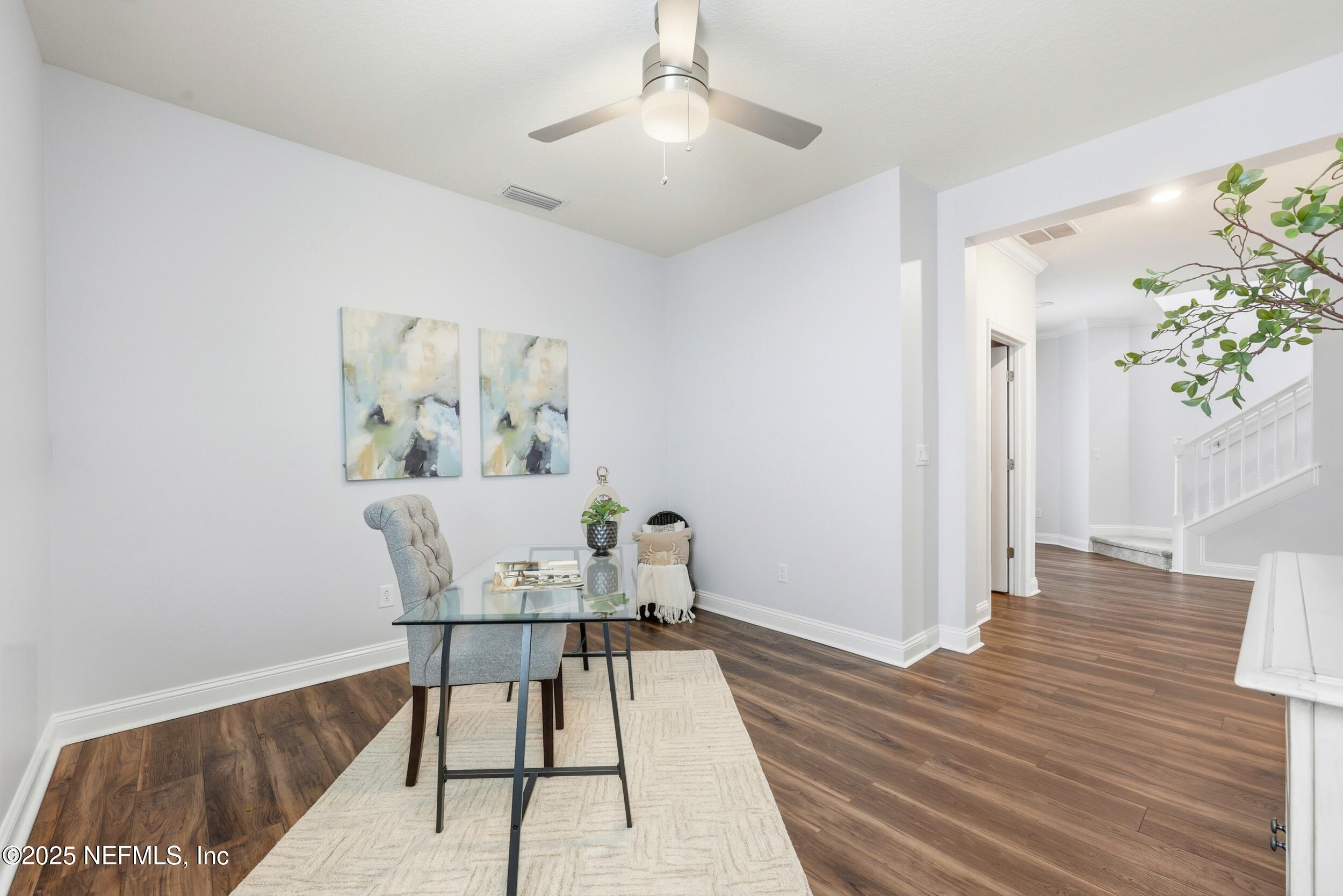 251 Rambling Brk Trail St. Johns, FL 32259 - Photo 21 of 40 a workspace with wooden floor and a potted plant