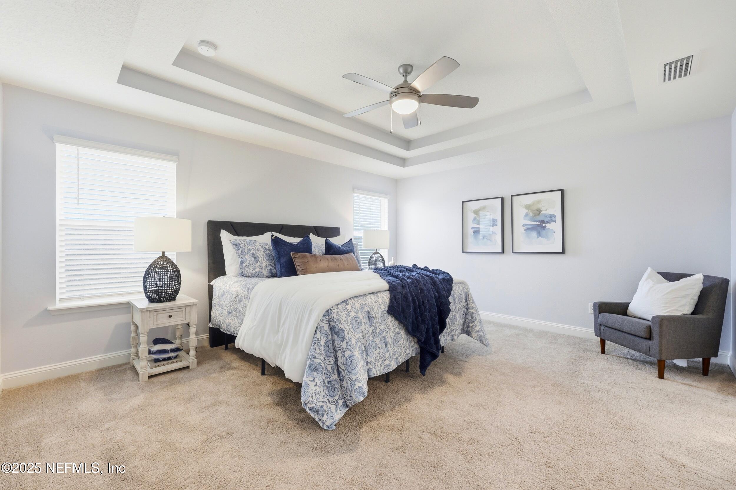 251 Rambling Brk Trail St. Johns, FL 32259 - Photo 22 of 40 a bedroom with a bed and a chandelier
