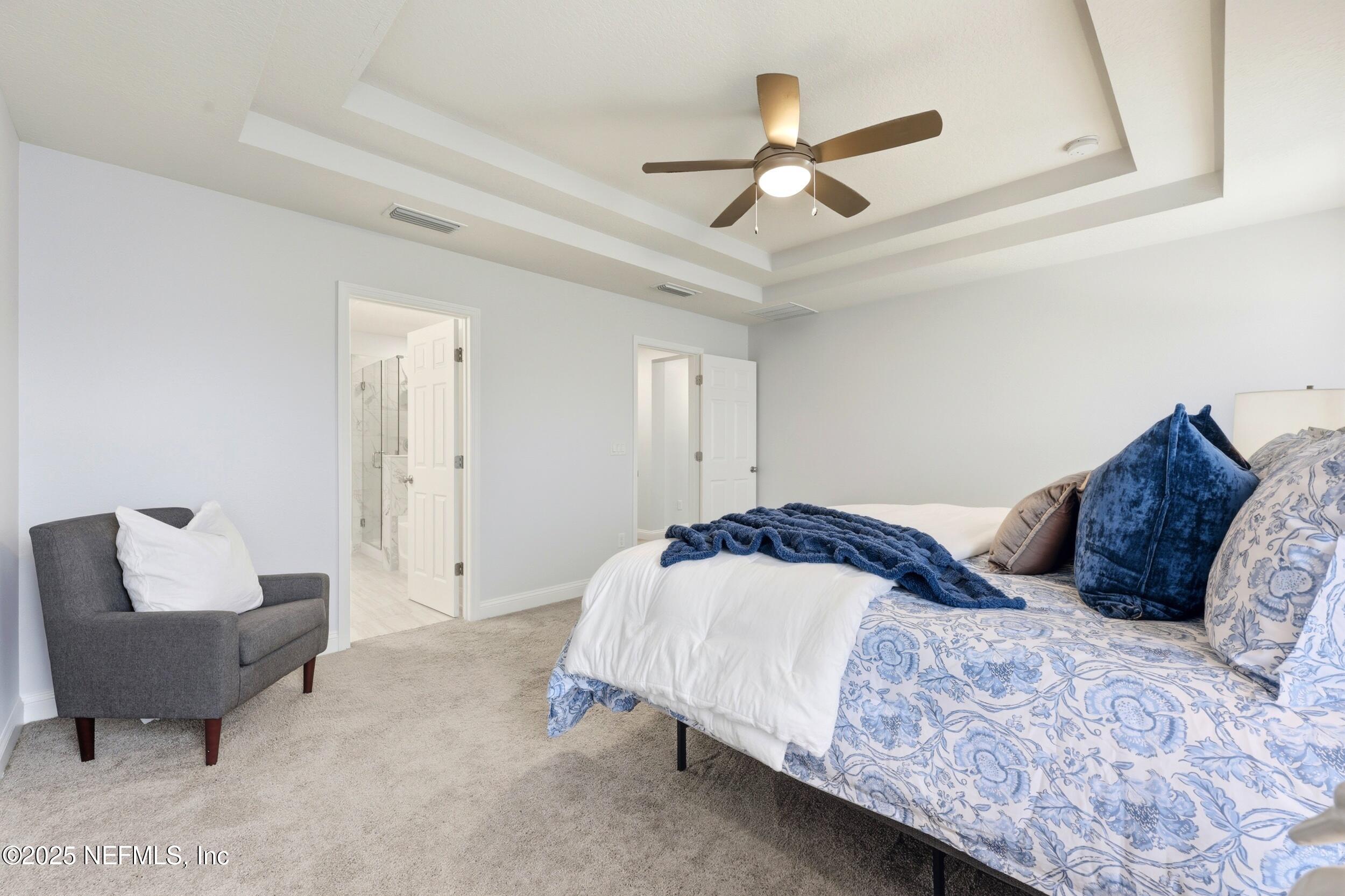 251 Rambling Brk Trail St. Johns, FL 32259 - Photo 23 of 40 a bedroom with a large bed and a couch