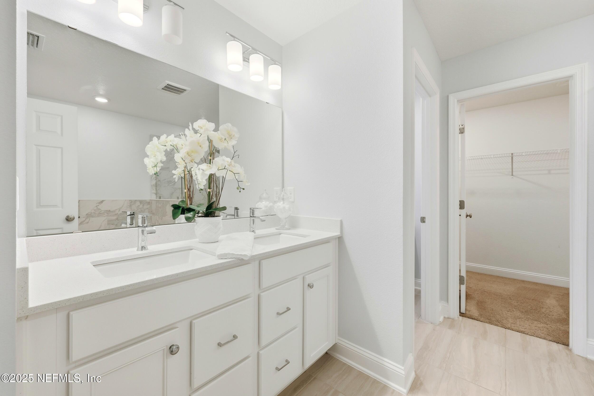 251 Rambling Brk Trail St. Johns, FL 32259 - Photo 25 of 40 a bathroom with a sink and a mirror