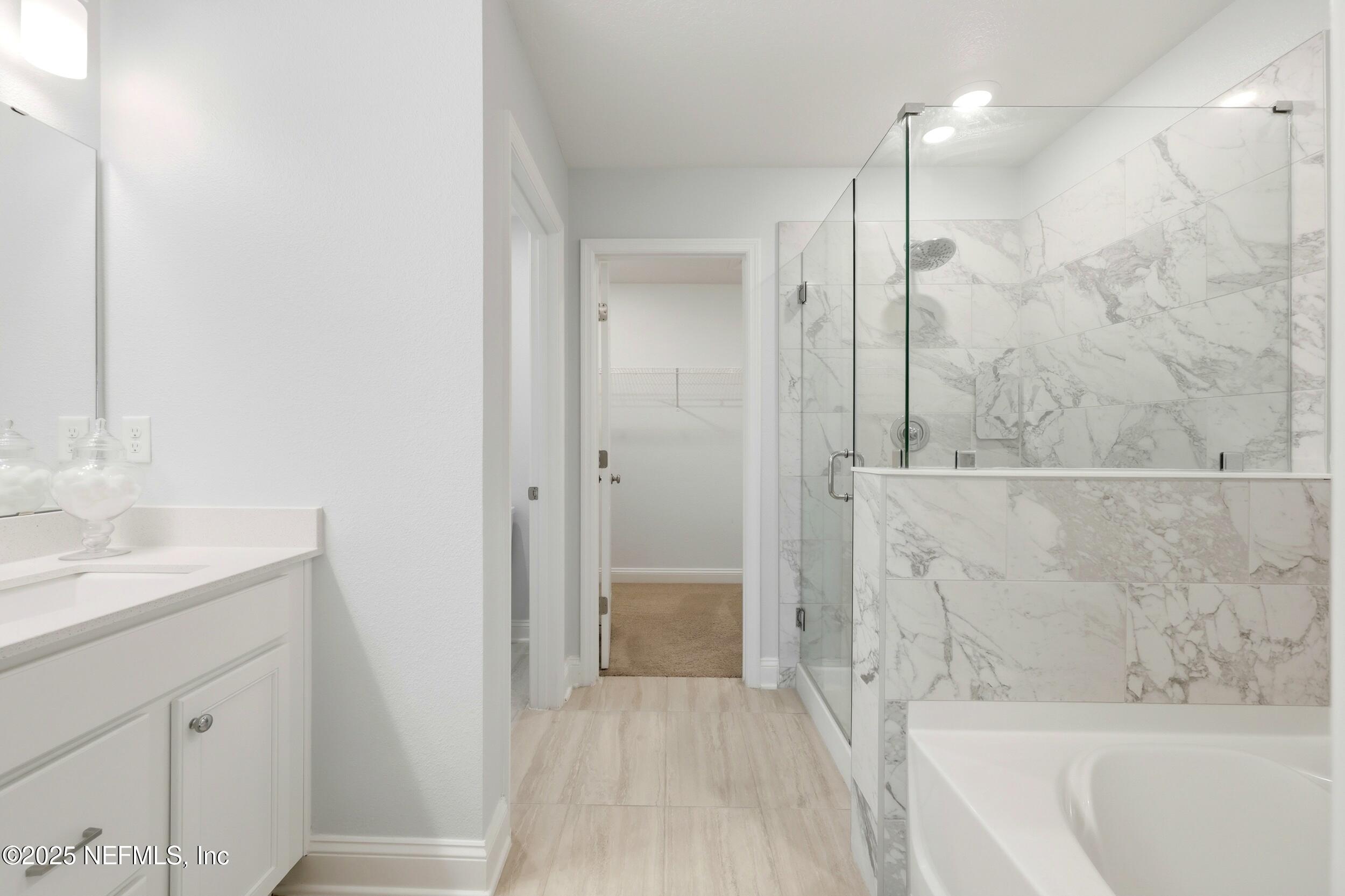 251 Rambling Brk Trail St. Johns, FL 32259 - Photo 28 of 40 a bathroom with a bathtub shower sink vanity and a mirror