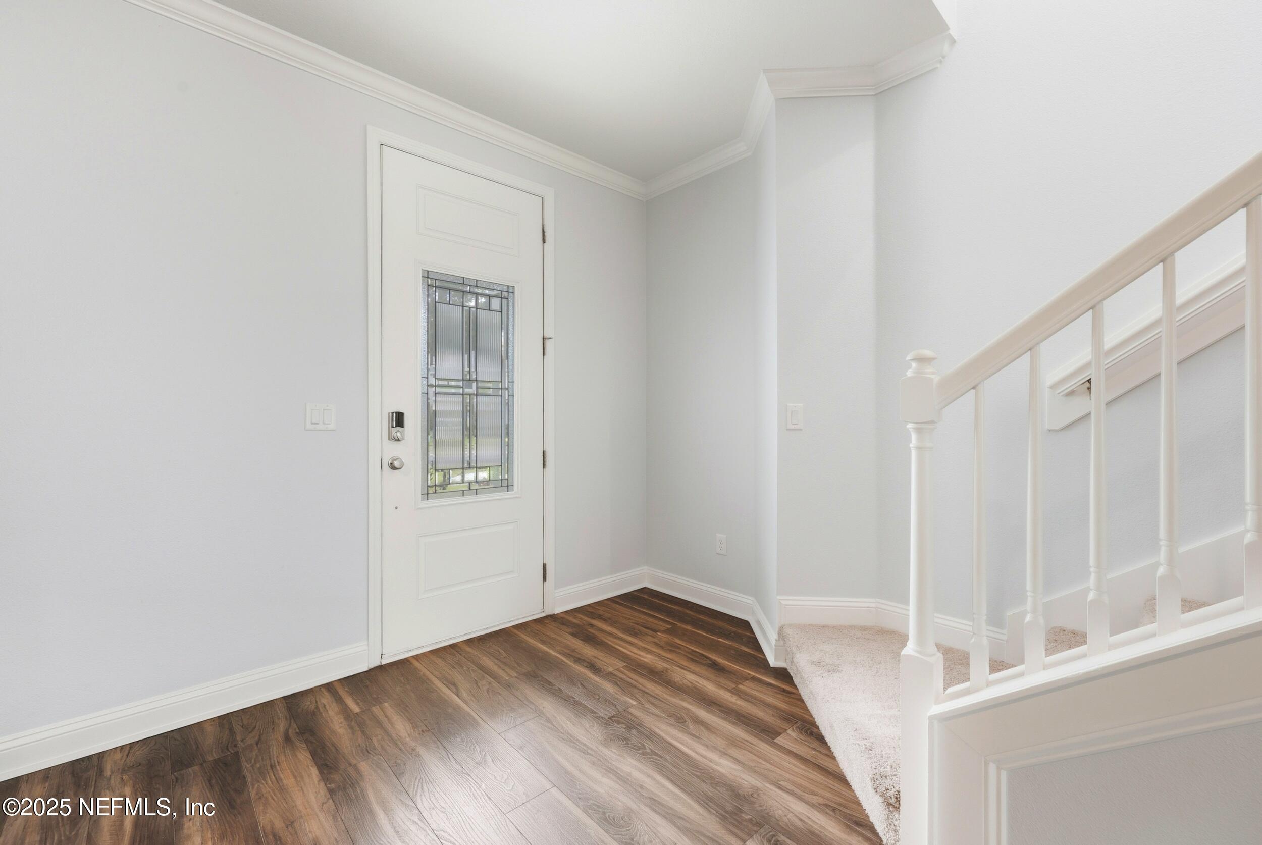 251 Rambling Brk Trail St. Johns, FL 32259 - Photo 5 of 40 a view of a hallway with wooden floor and entryway