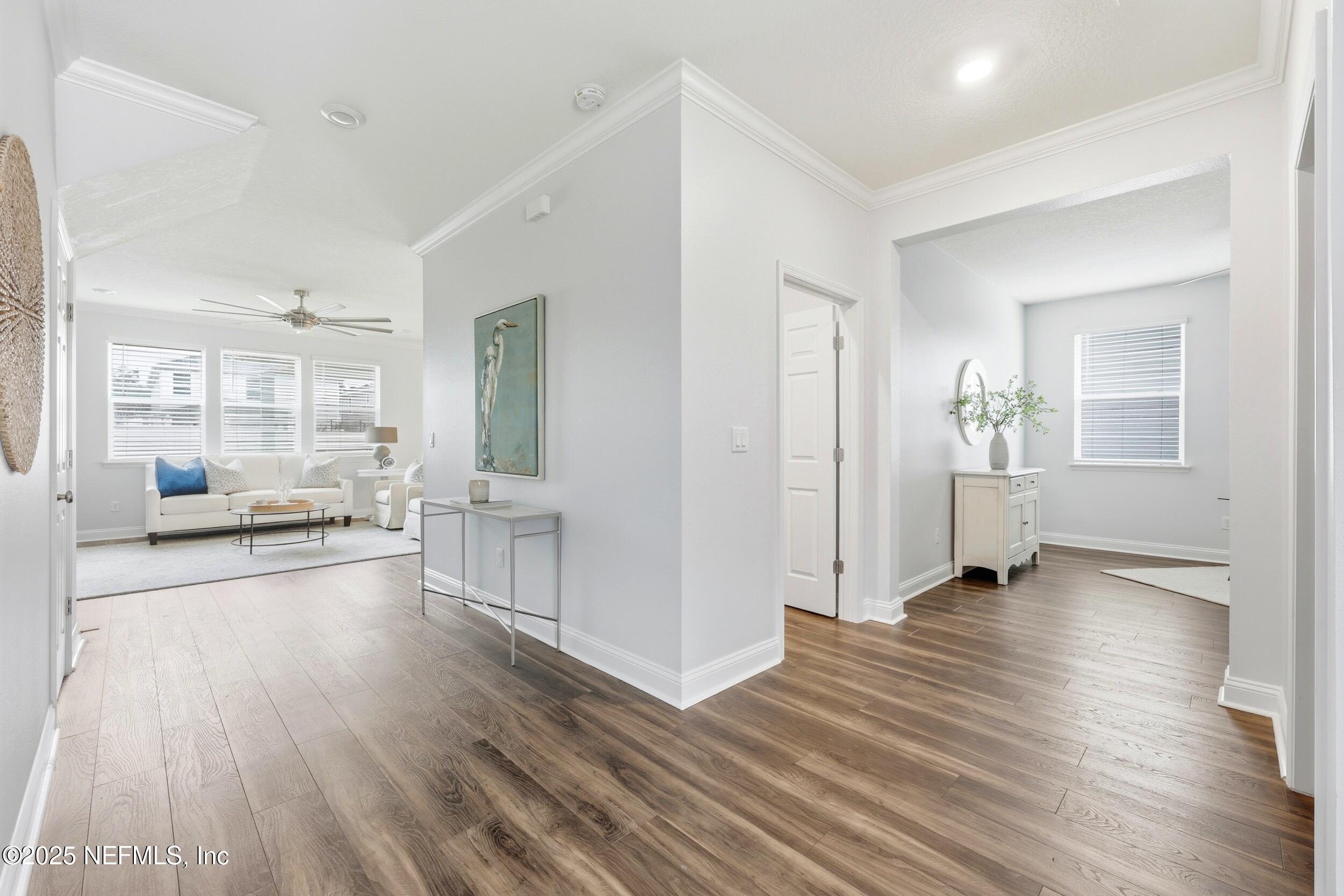 251 Rambling Brk Trail St. Johns, FL 32259 - Photo 7 of 40 a view of a big room with wooden floor and windows