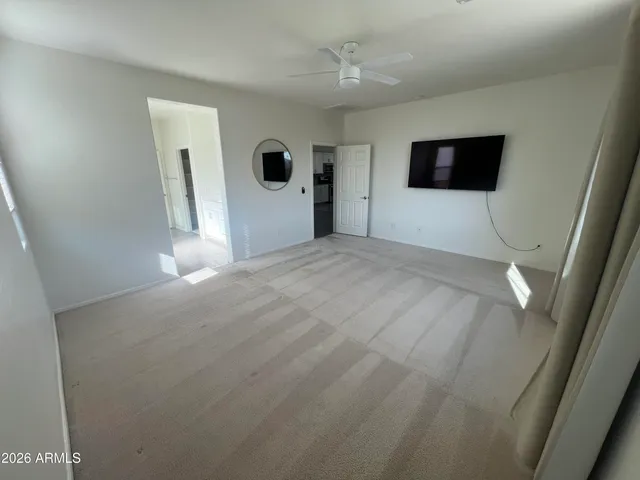 a view of walk in closet with clothes