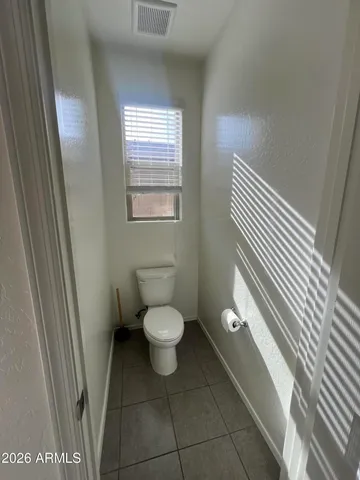 a view of a kitchen with kitchen island a sink stainless steel appliances and cabinets