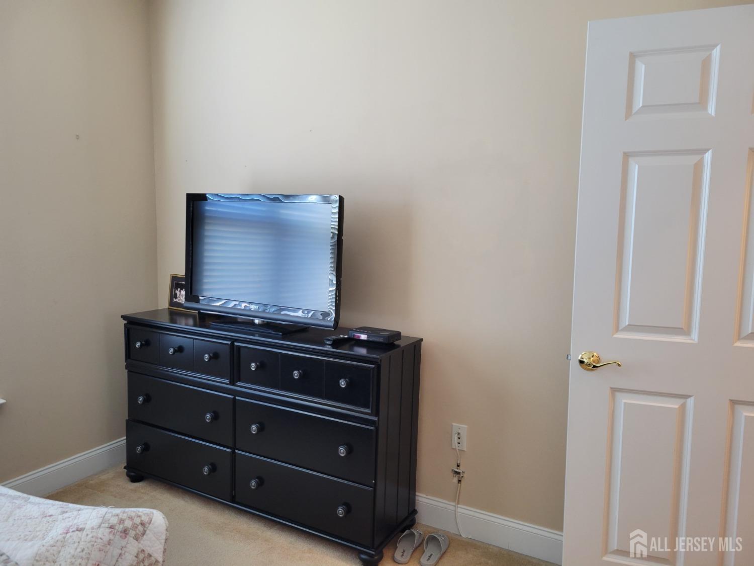 100 Middlesex Boulevard, Unit 341 Plainsboro, NJ 08536 - Photo 12 of 16 a room with a dresser and a mirror