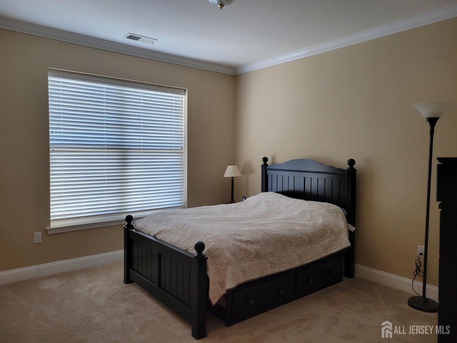 100 Middlesex Boulevard, Unit 341 Plainsboro, NJ 08536 - Photo 13 of 16 a bed sitting in a bedroom next to a window