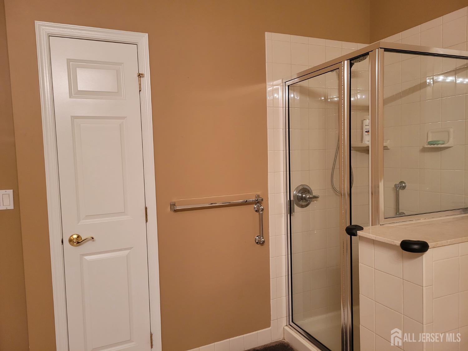 100 Middlesex Boulevard, Unit 341 Plainsboro, NJ 08536 - Photo 16 of 16 a bathroom with a glass shower door