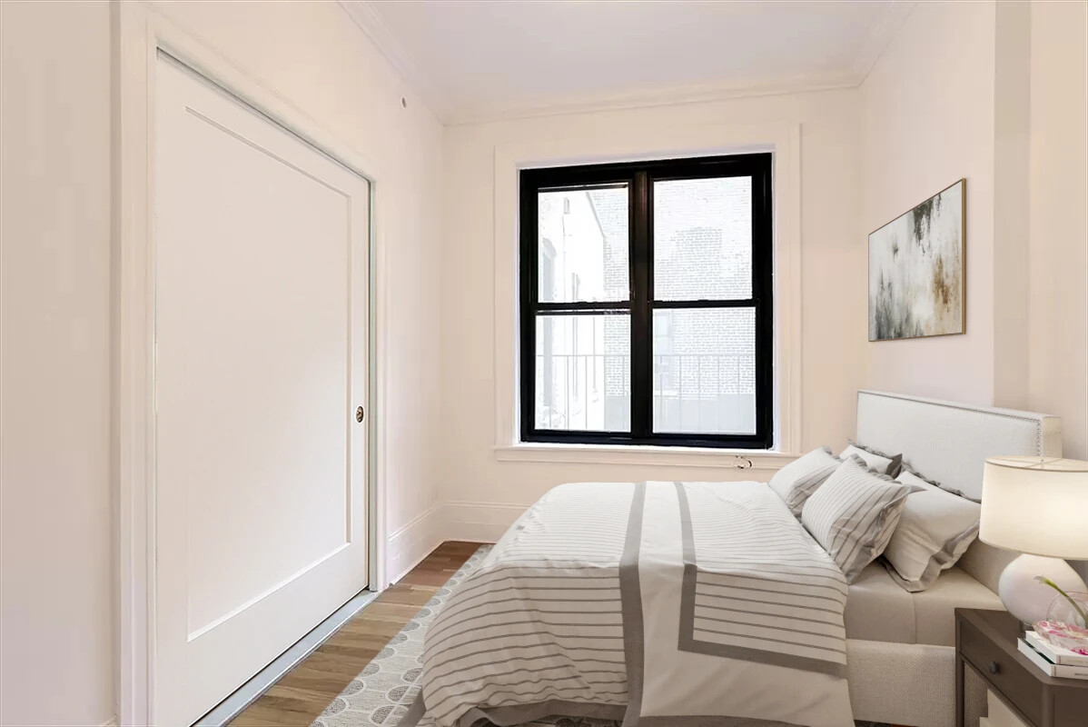 61 East 86th Street, Unit 76 Manhattan, NY 10028 - Photo 13 of 17 a bedroom with a bed and a window