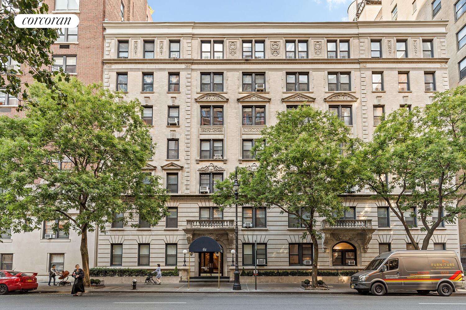 61 East 86th Street, Unit 76 Manhattan, NY 10028 - Photo 16 of 17 a front view of a building with lot of cars and trees