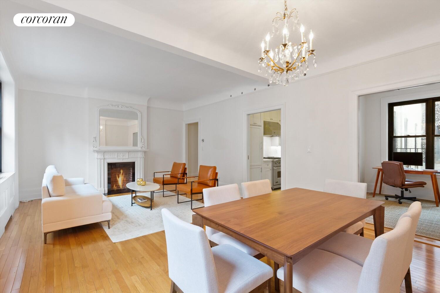 61 East 86th Street, Unit 76 Manhattan, NY 10028 - Photo 2 of 17 a living room with furniture a fireplace and a chandelier