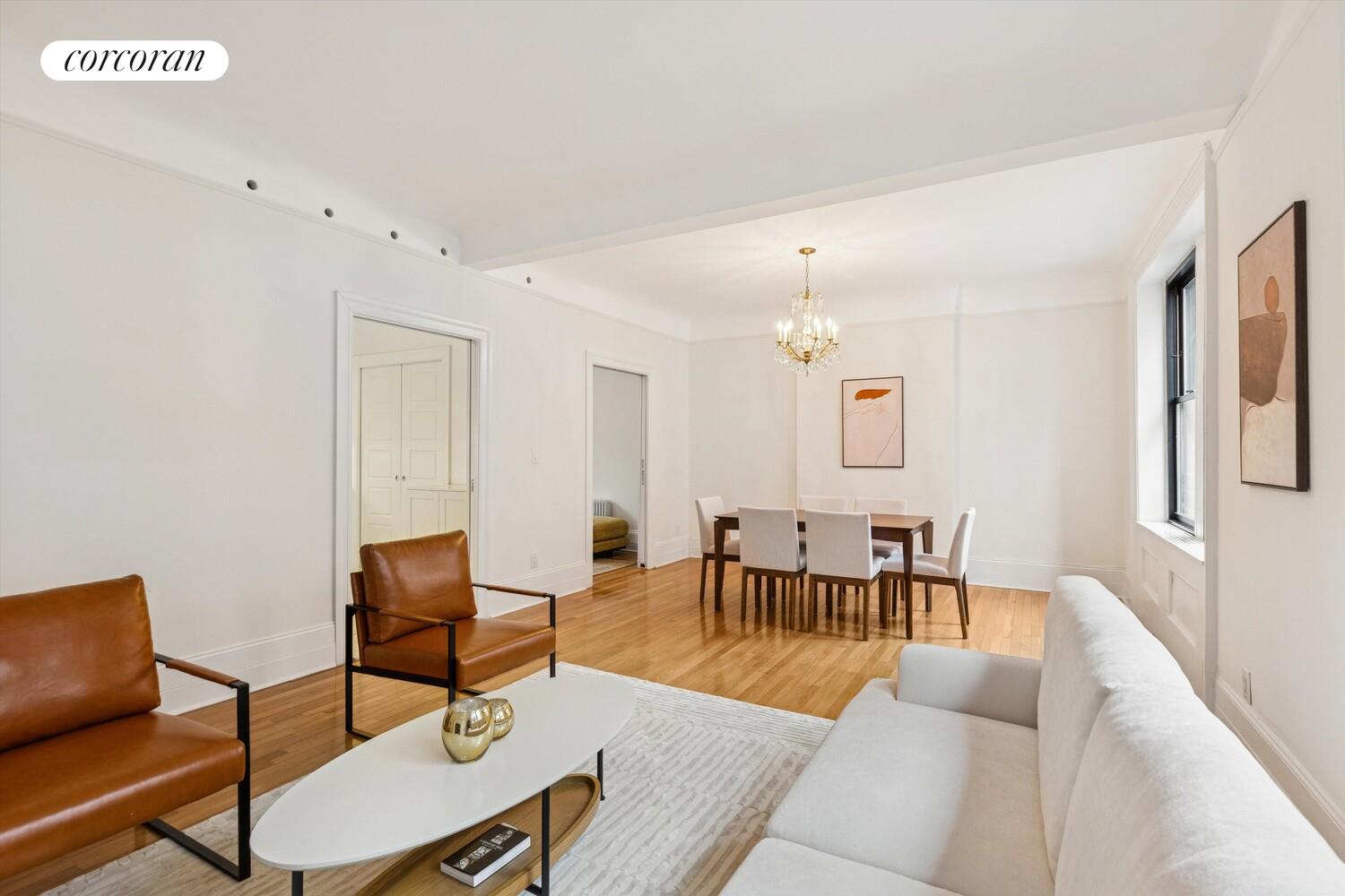 61 East 86th Street, Unit 76 Manhattan, NY 10028 - Photo 4 of 17 a living room with furniture and a dining table with rug