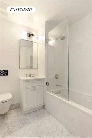 a bathroom with a shower sink and mirror
