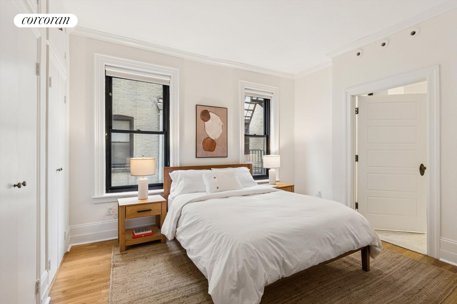 61 East 86th Street, Unit 76 Manhattan, NY 10028 - Photo 7 of 17 a bed room with a bed and a window