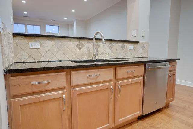 a view of kitchen with white cabinets